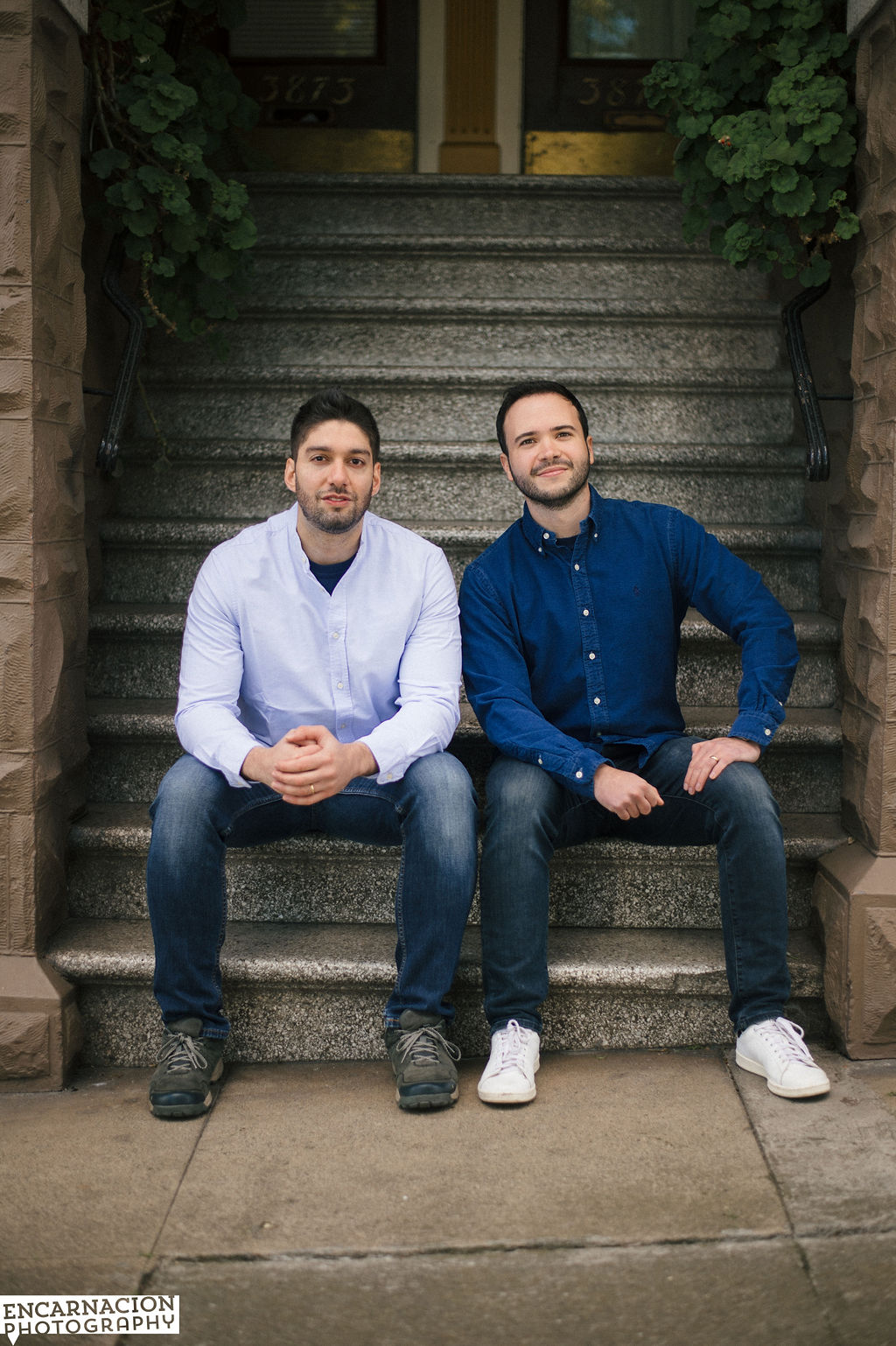 Cristian and Santi, co-founders of Autograph, sitting together on stone steps.
